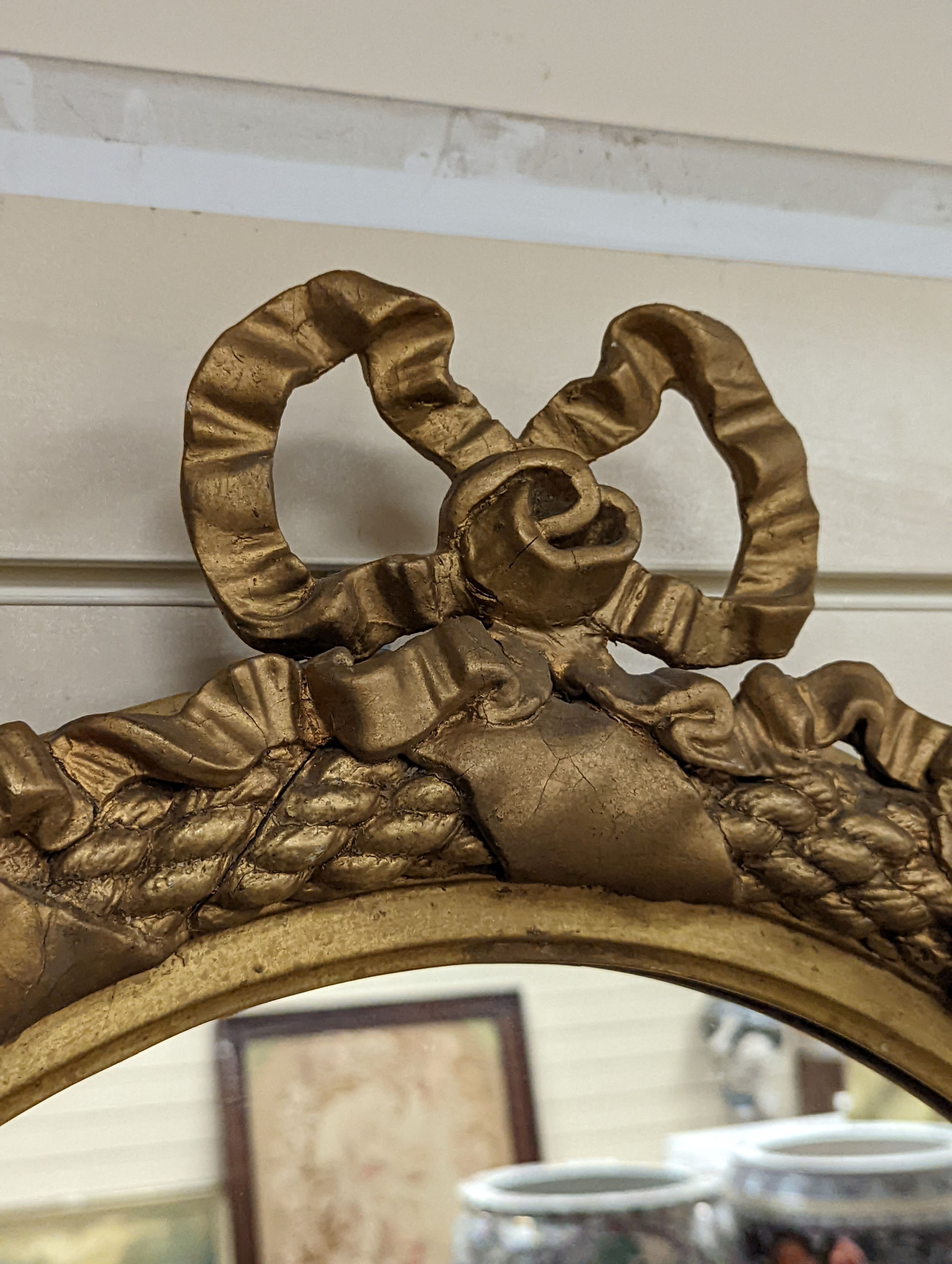 A Victorian gilt and composite mirror,, 99 cms high.